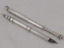 A silver combination dip pen and pencil