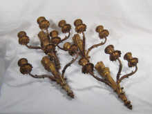 A set of four brass three branch