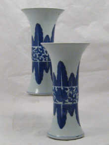 A pair of tall cylindrical blue 149e79