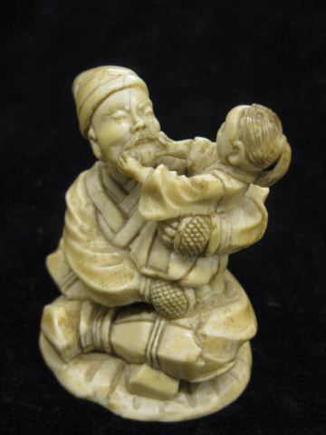 Carved Ivory Figure of an Old Man seated