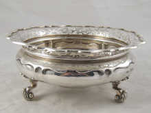 A silver bowl on three leaf capped
