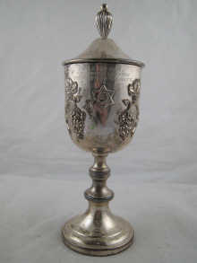 A white metal (tests silver) cup and