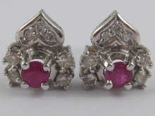 A pair of ruby and diamond stud