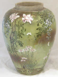 A large Oriental vase with applied flowers