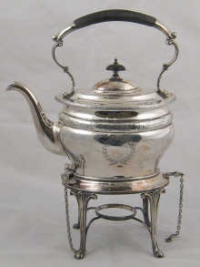 A silver oval kettle on stand with gadrooned
