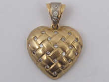 A 14 ct. gold heart pendant set with