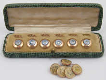 A boxed set of six buttons together