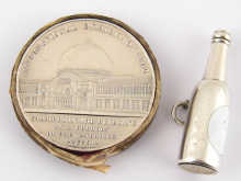 A white metal (tests silver) medallion