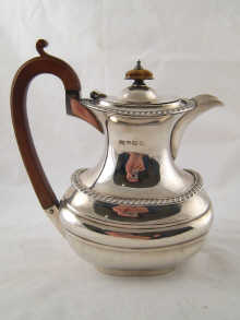 A silver jug with gadrooned rims by