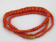 An antique graduated faceted coral bead