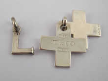 A white metal (tests silver) pendant