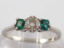 A three stone diamond and emerald