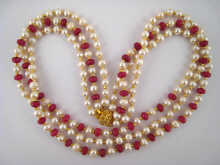 A faceted ruby bead and freshwater 14da8d