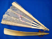 A ladys ivory and lace fan with hand
