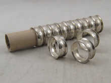 A set of 12 silver napkin rings