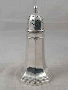 A silver lighthouse shaped caster