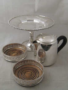 Silver plate. A pair of wine coasters