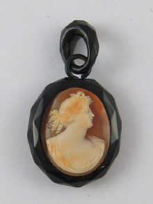 A shell cameo pendant set in jet