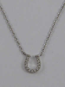 A diamond set horseshoe pendant