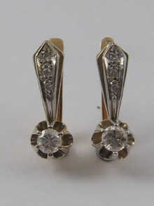 A pair of yellow and white metal 14de36