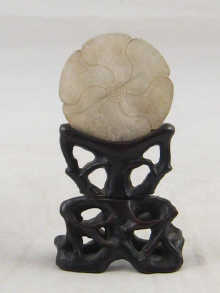 A Chinese jade disc carved as a