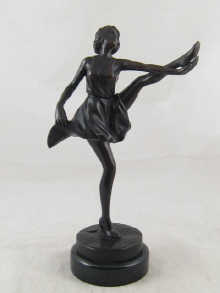 A bronze figure of a dancer incised