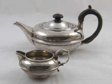 A matching silver teapot and cream