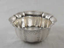 A silver fluted and chased sugar bowl