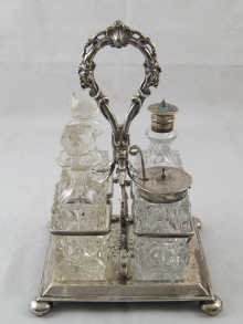 A four bottle cruet with silver