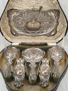 A boxed silver dressing table set