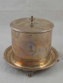 A silver biscuit barrel on four footed