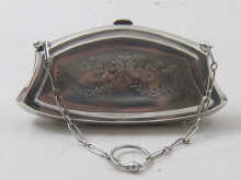 A silver purse with internal leather