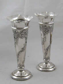 A pair of embossed silver spill