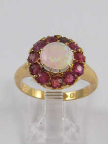 An opal ring surrounded by rubies 14df32