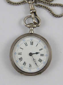 A silver fob watch on white metal (tests