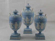 A suite of three blue jasper urns each