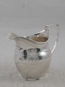 A Georgian silver service cream jug