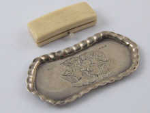 A silver pin tray embossed with