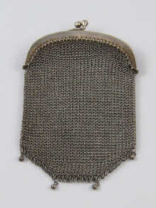 A small silver mesh purse with central