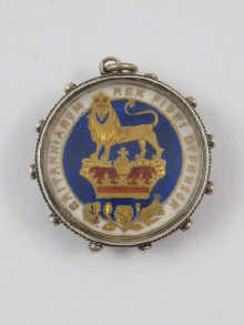 A commemorative pendant with inset coin.