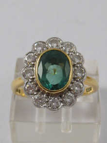 A diamond and emerald cluster ring 14dffd