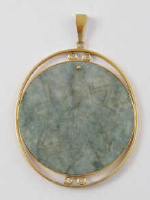 A green hardstone pendant set in