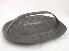 A Tudric pewter dish with handle decorated