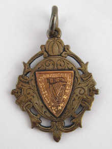 An Irish silver fob with applied gold