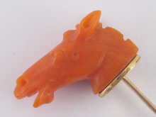 A carved coral stick pin designed 14e101