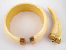 An ivory bangle and an ivory pendant 14e10e