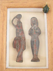 Two classical figures in glass fronted