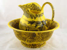 A yellow transfer printed jug and bowl