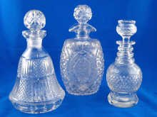 Three cut glass decanters one an oval