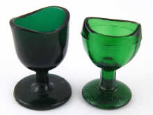 Two moulded green glass eye baths approx.